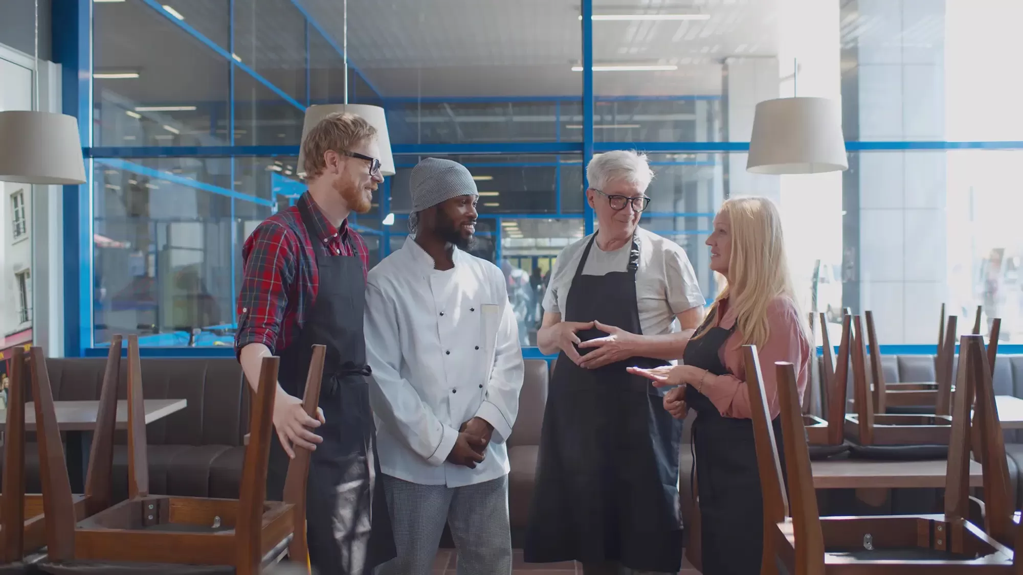 Adobe Stock 366710163 Multiethnic restaurant staff talking before opening copy