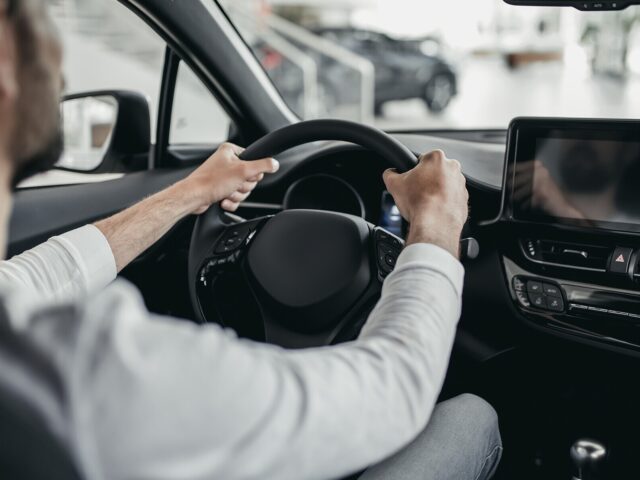 Man tests car in car dealership 978b8d064138018a1dfad71b9882dd21